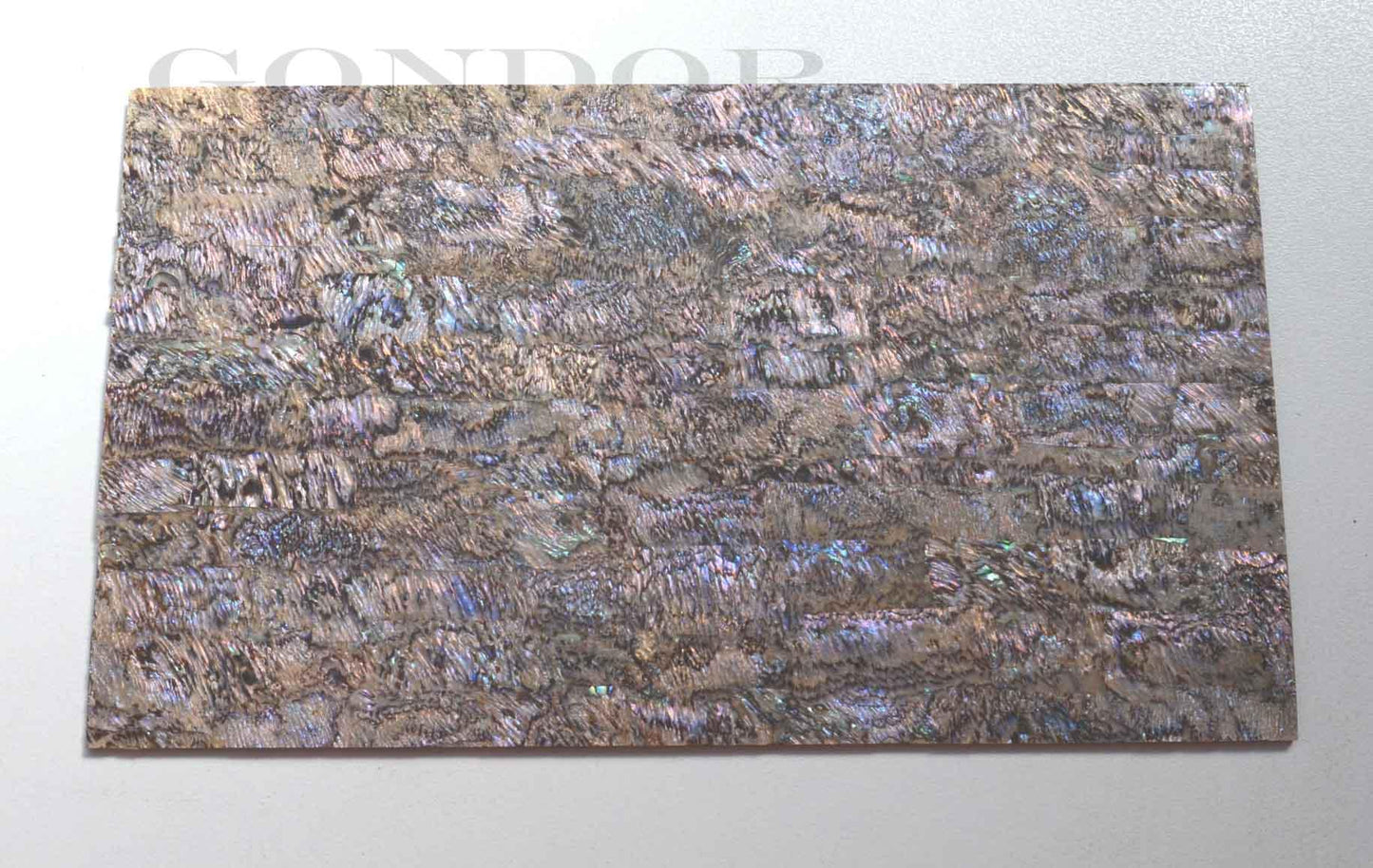 New Zealand Paua shell laminated shell sheets heart material made from genuine shell. Each sheet has shell throughout consisting of layers of smaller shell pcs. Sheet size 235 x 135mm (9.25 x 5.3"). Thickness 3mm (0.118") Ideal for inlay work, jewellery, knife handles. Economical and easy to cut. All layers are same consistency throughout the sheet.