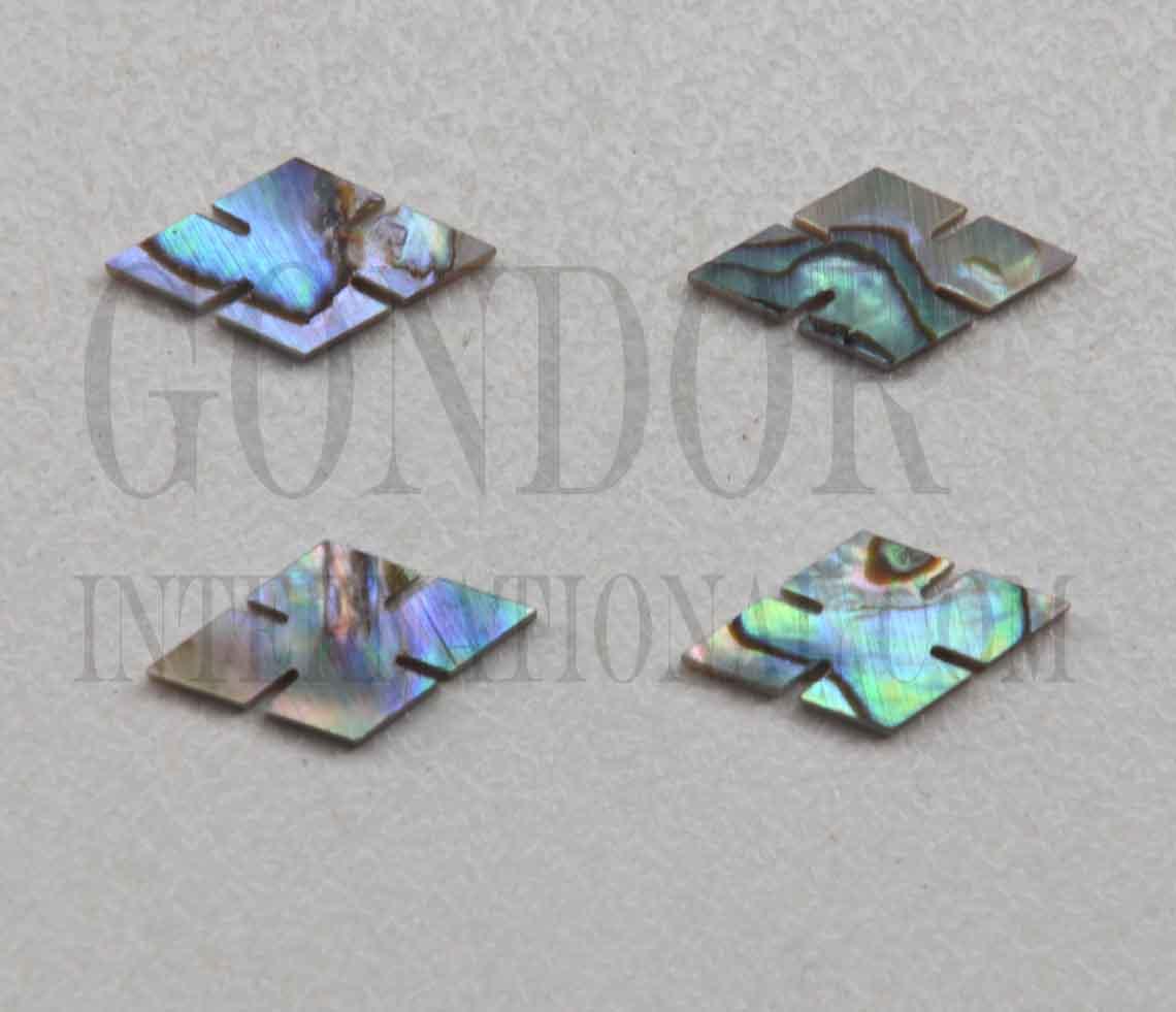 Paua abalone (New Zealand Paua abalone) notched diamonds (slotted diamonds) size 14.5mm (0.57") length x 7.5mm (0.295") width x 1.5mm (0.06") thickness. Some uses include fretboard markers, musical instrument inlay, furniture inlay, marquetry, pool cue inlay and other general decorative inlay and jewellery applications. All pcs are A grade.