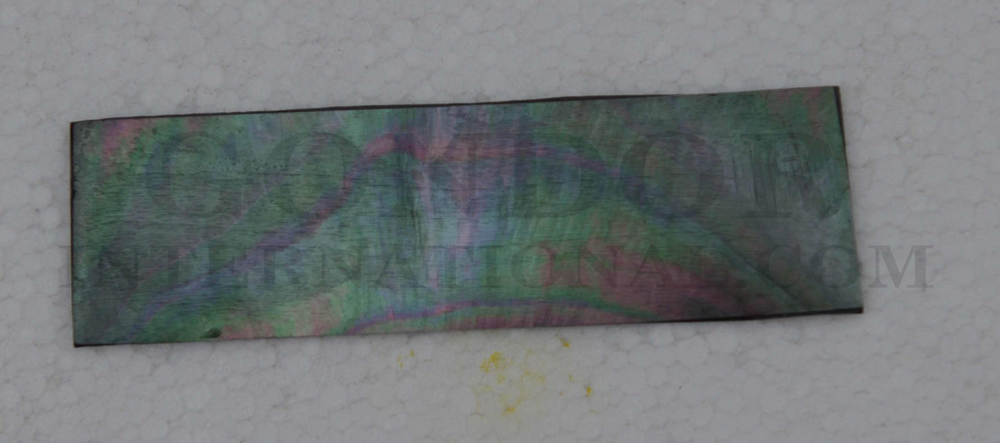 Black MOP shell inlay feathers consist of single piece solid shell face layer 0.5mm thick laminated to shell laminate backing size 33 width x 95-110mm length x .1.6mm total thickness (including 1.1mm laminated sheet backing). Suitable for inlays, marquetry. <br />