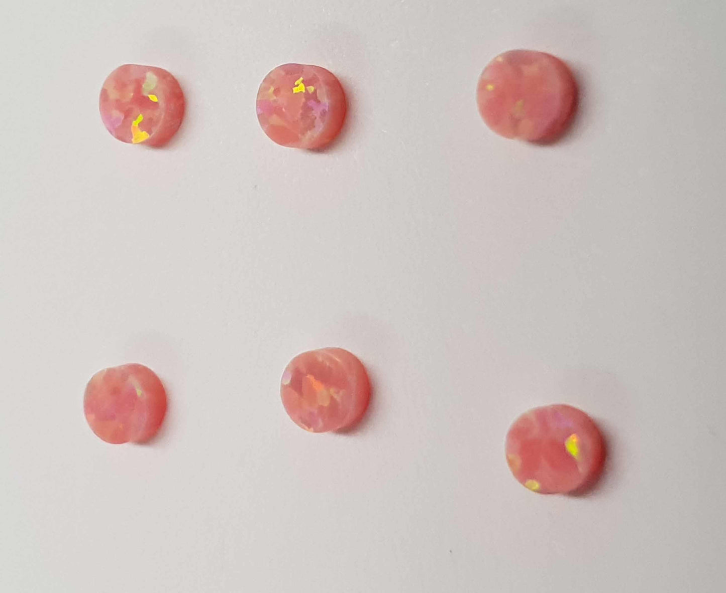 <p>Opal dots OP24 3 x 1.3mm flat pcs made to specific diameter and thickness made from manufactured opal suitable for inlay, fretboard markers, jewellery, Opal dots can be worked same way as mother of pearl and are of similar hardness.</p>