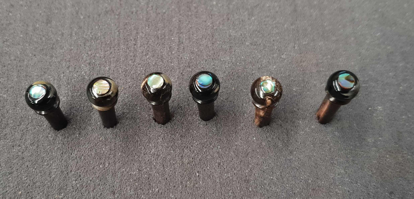 1 set (6pcs) Guitar bridge pins size 1Buffalo horn with abalone dot Tapered shaft string slot running the full length of shaft. Diameter at top of shaft 5.3mm (0.21") length of shaft 22.9mm (0.9") . Will fit the following models - Martin guitars prior to 1994 (except HD-28), Collings guitars, prior to 2002, Blanchard, Garrison, Goodall, Ryan, Santa Cruz, Taylor, Larrivee D-03R and others.