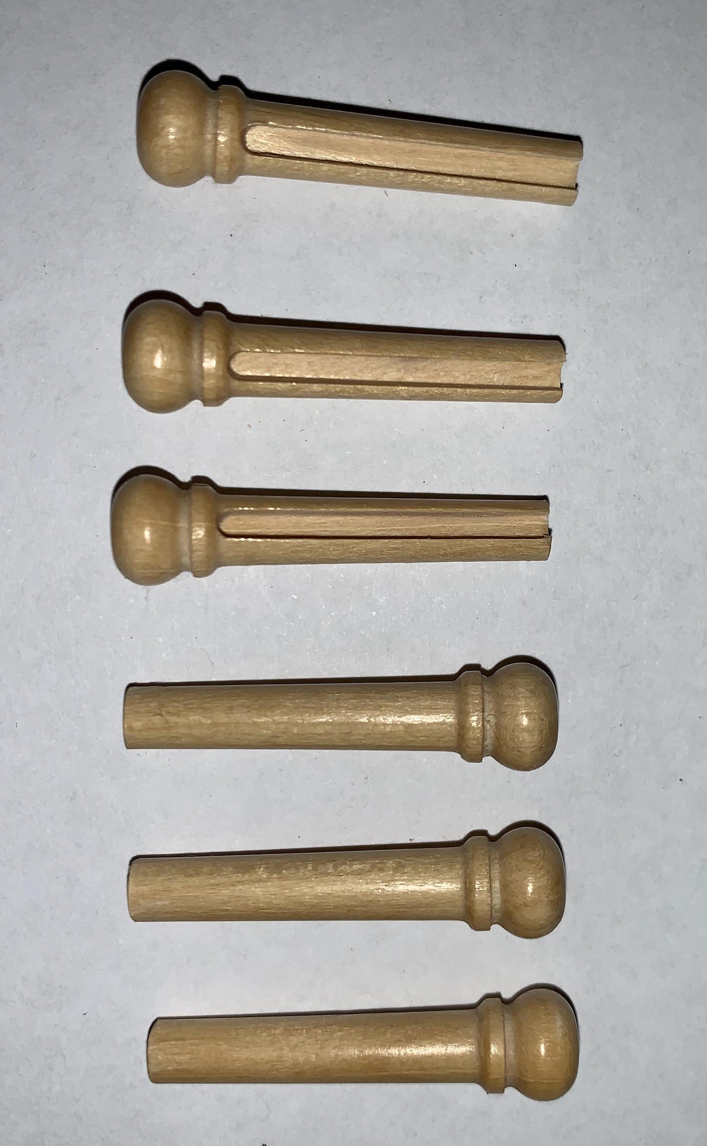 1 set (6pcs) Guitar bridge pins size 1 Ivory wood Tapered shaft string slot running the full length of shaft. Diameter at top of shaft 5.3mm (0.21") length of shaft 22.9mm (0.9") . Will fit the following models - Martin guitars prior to 1994 (except HD-28), Collings guitars, prior to 2002, Blanchard, Garrison, Goodall, Ryan, Santa Cruz, Taylor, Larrivee D-03R and others.