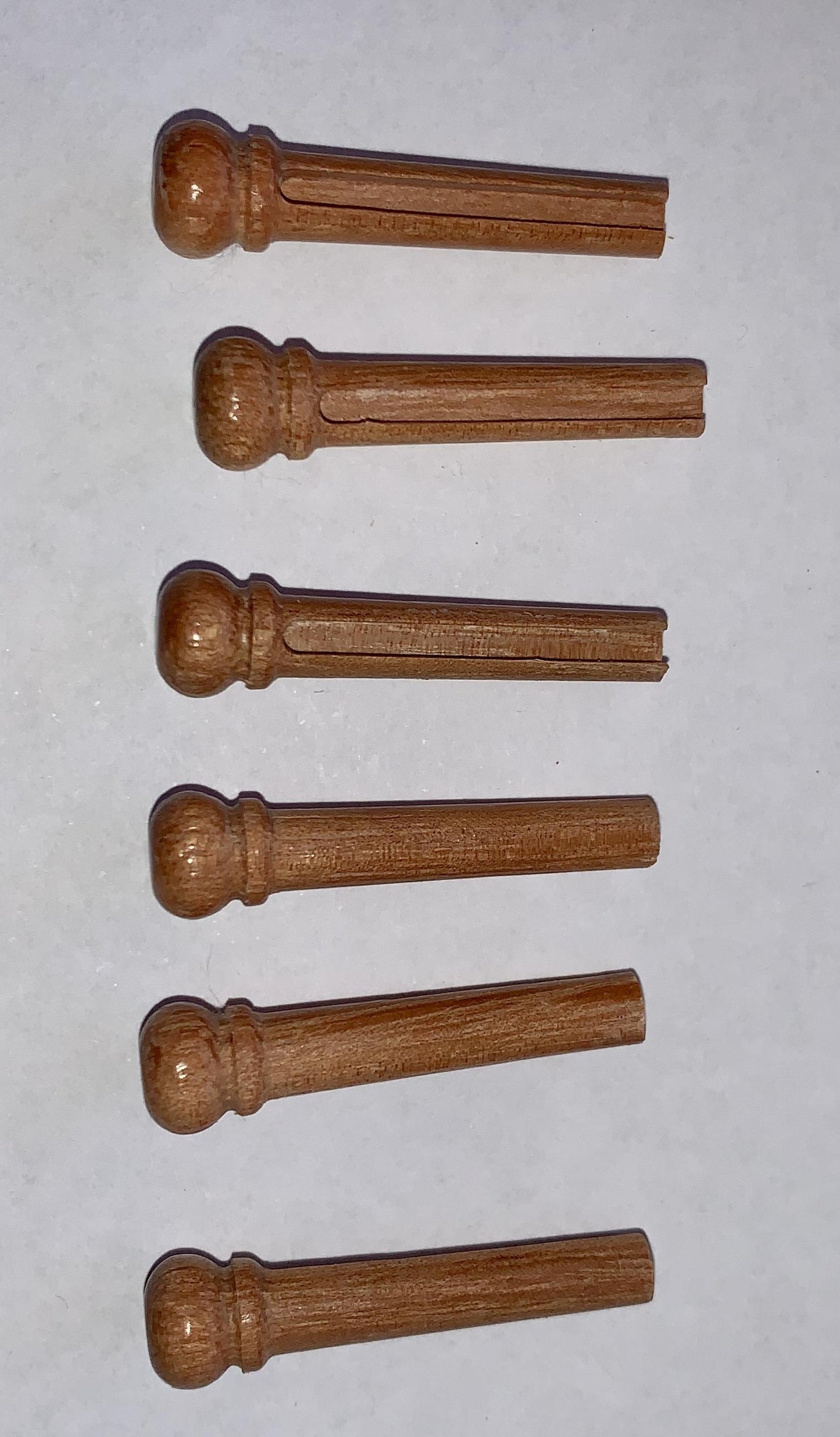 1 set (6pcs) Guitar bridge pins Australian Southern Mahogany size 1 Tapered shaft string slot running the full length of shaft. Diameter at top of shaft 5.3mm (0.21") length of shaft 22.9mm (0.9") . Will fit the following models - Martin guitars prior to 1994 (except HD-28), Collings guitars, prior to 2002, Blanchard, Garrison, Goodall, Ryan, Santa Cruz, Taylor, Larrivee D-03R and others.