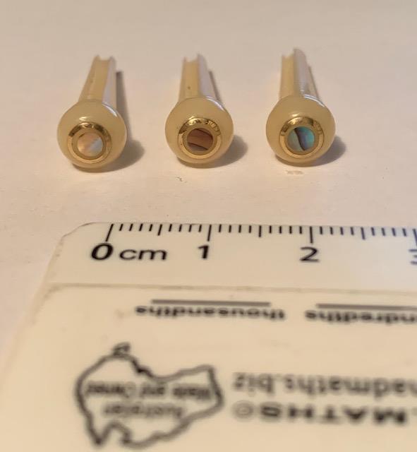 1 set (6pcs) Guitar bridge pins size 2A Vintage bone with brass and Paua dot. Tapered shaft string slot running the full length of shaft. Diameter at top of shaft 5.6mm (0.22") length of shaft 25.5mm (1") . Will fit the following models - Martin guitars since 1994,as well as D-28 older Gibson guitars,and others.