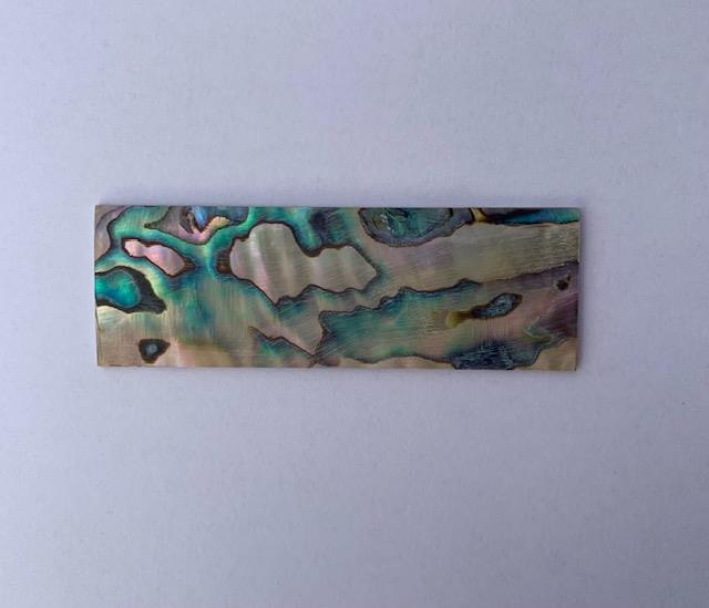 <p>Green abalone shell inlay feathers consist of single piece solid shell face layer 1.6mm thick laminated to shell laminate backing size 27 width x 75-95mm length x .1.6mm total thickness (including 1.1mm laminated sheet backing). Suitable for inlays, marquetry.</p>