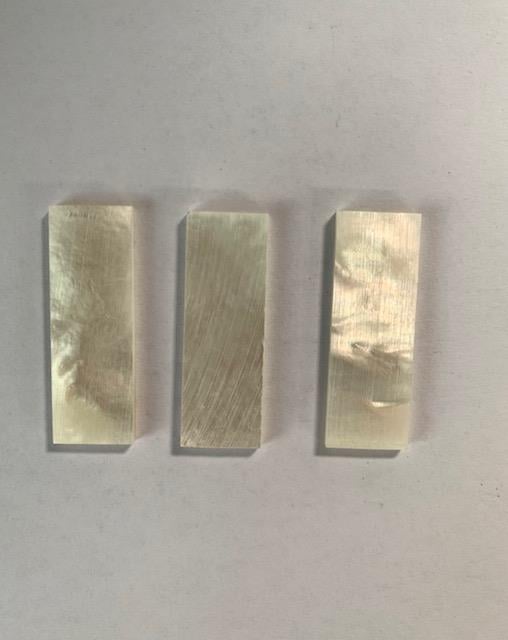 <p>White Mother of Pearl flat figured inlay blanks size 12mm (0.47") width x 35mm (1.38") length x 2mm (0.08") thickness. A grade good on both sides.</p>
