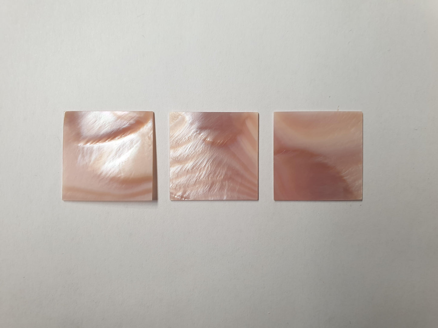 <p>Pink mussel flat inlay blanks 25 x 25 x 0.5mm (1 x 1 x 0.0197") A grade. polished 1 side</p>