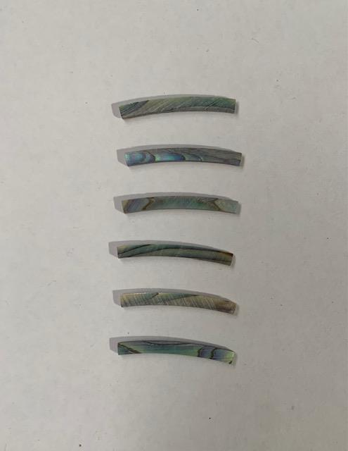 <p>Paua abalone laminated shell curved strips 2mm (0.08") width x 20mm (0.8") length x 1.5mm (0.06") thickness x 220mm (8.67") inside diameter. A grade quality good on both sides, flat and uniform in thickness and width. Ideal for use in purfling and rosettes on musical instruments - Ukuleles, guitars, mandolins etc. as well as in furniture, jewellery and other decorative applications.</p>