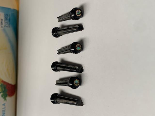 1 set (6pcs) Guitar bridge pins buffalo horn brass with paua dot size 1 Tapered shaft string slot running the full length of shaft. Diameter at top of shaft 5.3mm (0.21") length of shaft 22.9mm (0.9") . Will fit the following models - Martin guitars prior to 1994 (except HD-28), Collings guitars, prior to 2002, Blanchard, Garrison, Goodall, Ryan, Santa Cruz, Taylor, Larrivee D-03R and others.