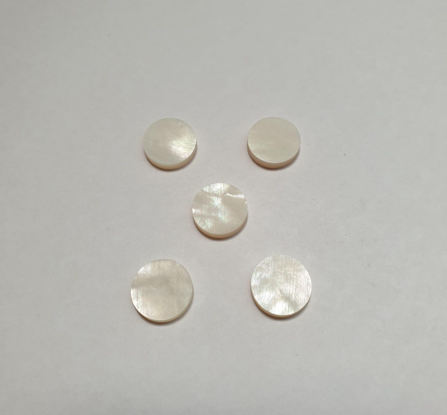 <p>White Mother of Pearl dots 12mm (0.472") diameter x 2.5mm (0.098") thickness - round flat shell pcs cut to precise diameter and thickness. Ideal for use in inlay applications - for fretboard markers, bow frog eyes, watch dials, button blanks and general inlay or jewellery decorations. All dots are A grade good on both sides. </p>