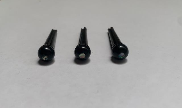 1 set (6pcs) Guitar bridge pins size 2A ebony with paua dot. Tapered shaft string slot running the full length of shaft. Diameter at top of shaft 5.6mm (0.22") length of shaft 25.5mm (1") . Will fit the following models - Martin guitars since 1994,as well as D-28 older Gibson guitars,and others.