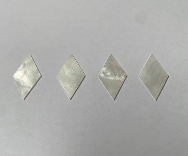 <p>White Mother of Pearl Rhombus size 12.5mm width x 22.5mm height x 0.6mm thickness. Some uses include fretboard markers, musical instrument inlay, furniture inlay and other general decorative inlay and jewellery applications. All pcs are A grade.</p>