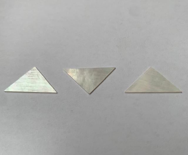 <p>White Mother of Pearl triangle size 22mm width x 11.5mm height x 0.6mm thickness. Some uses include fretboard markers, musical instrument inlay, furniture inlay and other general decorative inlay and jewellery applications. All pcs are A grade.</p>