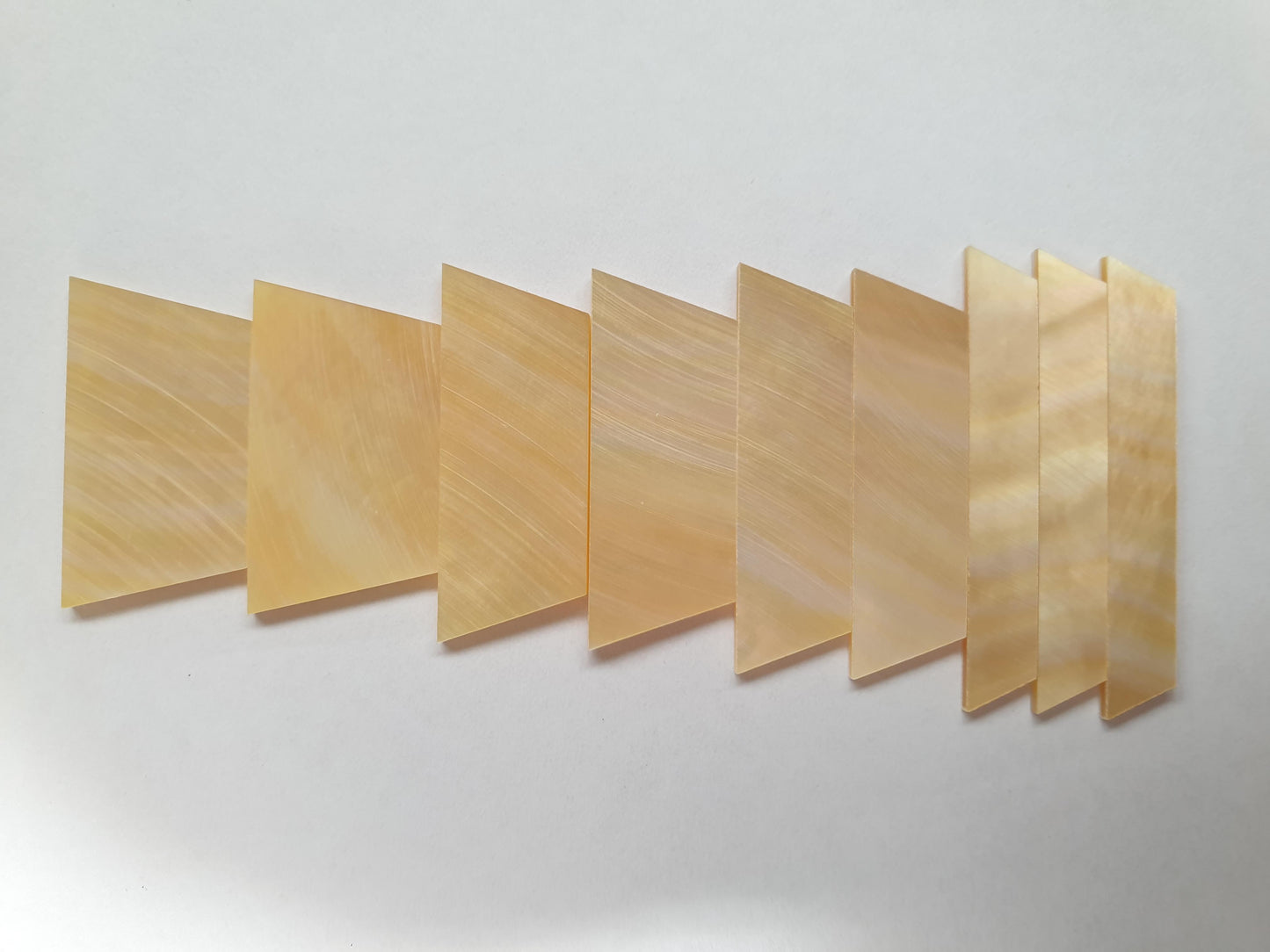 A set of 9pcs Gold MOP trapezoid inlays. Suitable for Les Paul or SG style guitars. Shell thickness 1.5mm. Flat and ready to be installed.