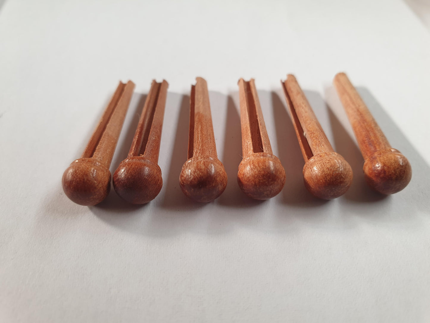 1 set (6pcs) Guitar bridge pins size 2A Australian Rosewood. Tapered shaft string slot running the full length of shaft. Diameter at top of shaft 5.6mm (0.22") length of shaft 25.5mm (1") . Will fit the following models - Martin guitars since 1994,as well as D-28 older Gibson guitars,and others.