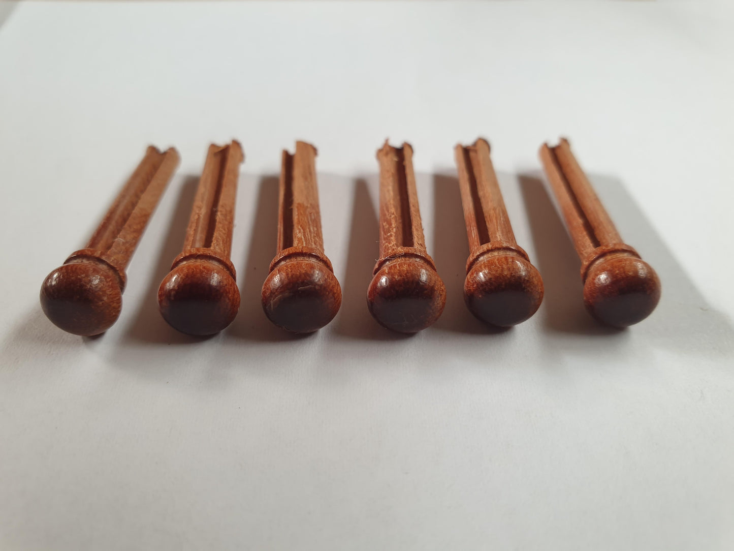 1 set (6pcs) Guitar bridge pins Australian Rosewood size 1 Tapered shaft string slot running the full length of shaft. Diameter at top of shaft 5.3mm (0.21") length of shaft 22.9mm (0.9") . Will fit the following models - Martin guitars prior to 1994 (except HD-28), Collings guitars, prior to 2002, Blanchard, Garrison, Goodall, Ryan, Santa Cruz, Taylor, Larrivee D-03R and others.