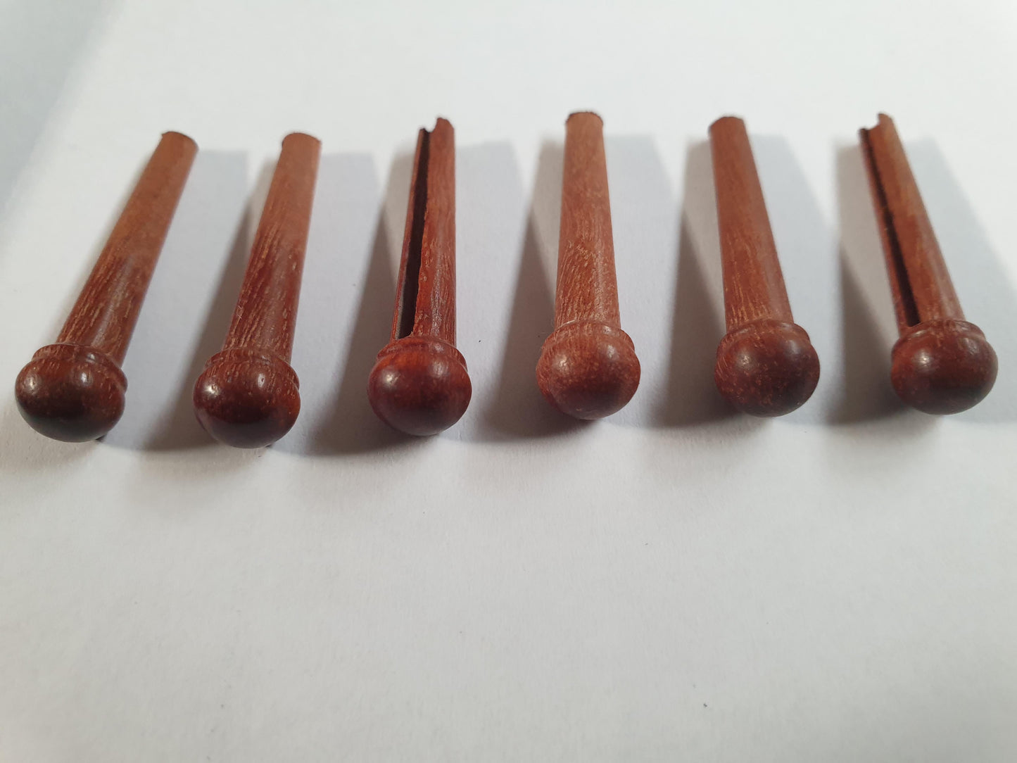 1 set (6pcs) Guitar bridge pins size 2A Red Gum. Tapered shaft string slot running the full length of shaft. Diameter at top of shaft 5.6mm (0.22") length of shaft 25.5mm (1") . Will fit the following models - Martin guitars since 1994,as well as D-28 older Gibson guitars,and others.