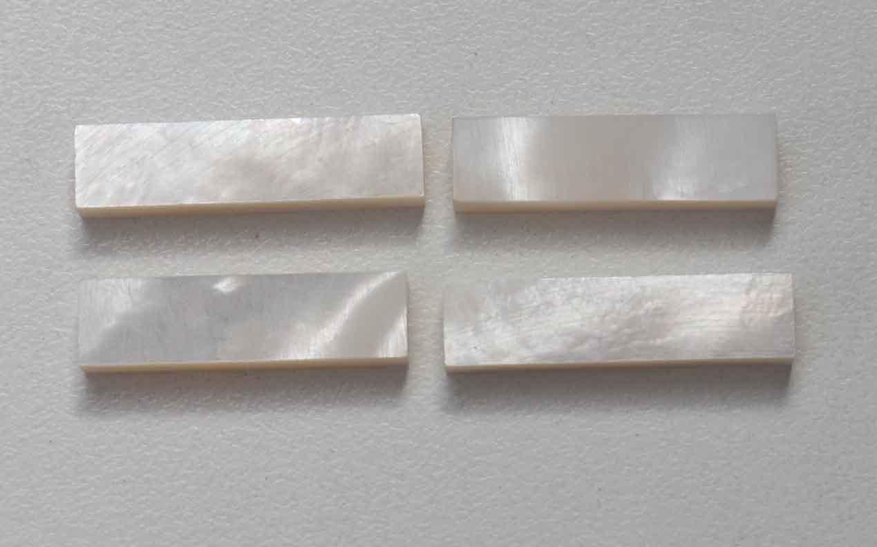 <p>White Mother of Pearl flat nut blanks size 8mm (0.315" width x 45mm (1.77") length x 6mm (0.236") thickness A grade good on both sides.</p>