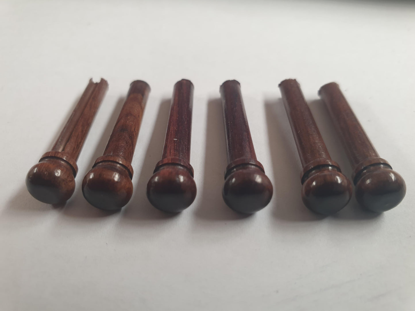 1 set (6pcs) Guitar bridge pins size 1 Rosewood Tapered shaft string slot running the full length of shaft. Diameter at top of shaft 5.3mm (0.21") length of shaft 22.9mm (0.9") . Will fit the following models - Martin guitars prior to 1994 (except HD-28), Collings guitars, prior to 2002, Blanchard, Garrison, Goodall, Ryan, Santa Cruz, Taylor, Larrivee D-03R and others.