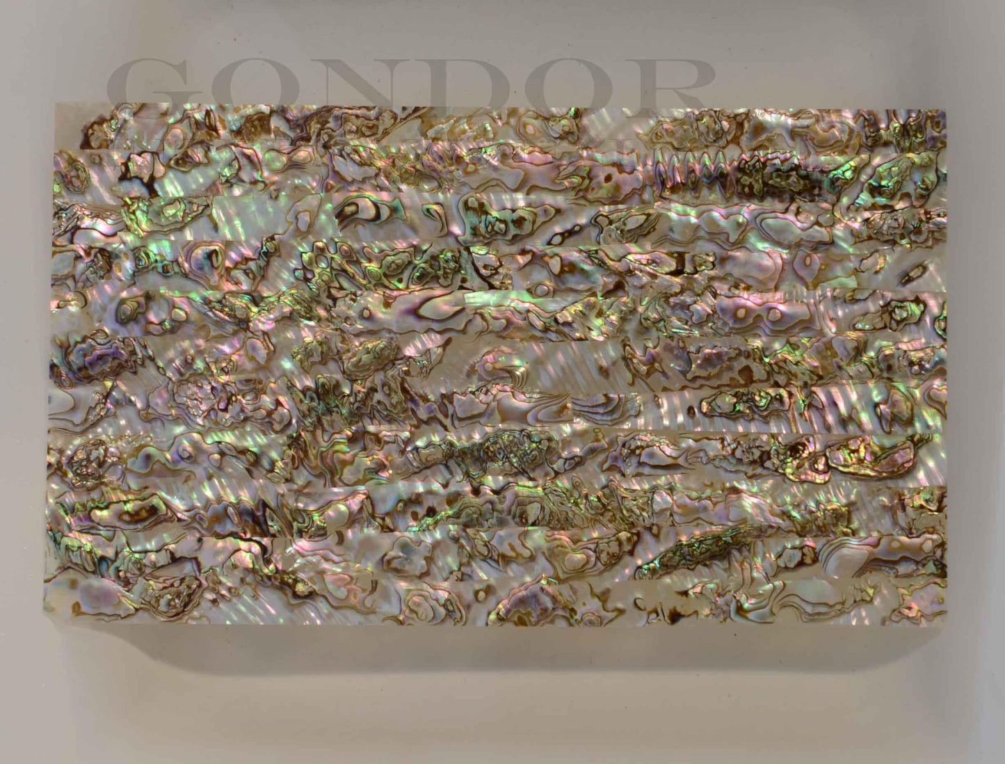 Green abalone B grade shell veneer also called Mexican green abalone sheet or Green abalone shell paper. Made from thin slices of genuine shell. Sheet size 240 x 140mm average thickness 0.5mm B grade sheets may have some worm holes and shell skin. Suitable for signwriting, marquetry, fishing lures, jewellery, architectural application, furniture and many other applications. Available with options - self adhesive backing, colour coating 1 side and a combination of colour coating and self adhesive.