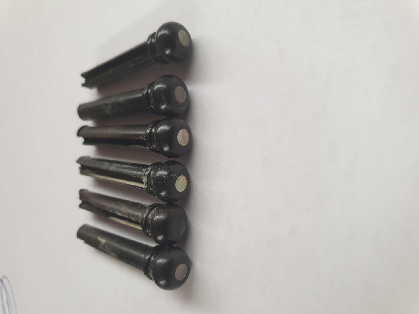 1 set (6pcs) Guitar bridge pins size 1 Ebony with Black MOP dot Tapered shaft string slot running the full length of shaft. Diameter at top of shaft 5.3mm (0.21") length of shaft 22.9mm (0.9") . Will fit the following models - Martin guitars prior to 1994 (except HD-28), Collings guitars, prior to 2002, Blanchard, Garrison, Goodall, Ryan, Santa Cruz, Taylor, Larrivee D-03R and others.