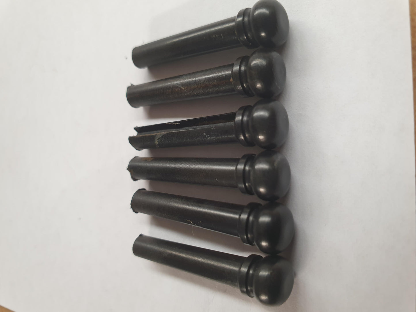 1 set (6pcs) Guitar bridge pins size 1 Ebony Tapered shaft string slot running the full length of shaft. Diameter at top of shaft 5.3mm (0.21") length of shaft 22.9mm (0.9") . Will fit the following models - Martin guitars prior to 1994 (except HD-28), Collings guitars, prior to 2002, Blanchard, Garrison, Goodall, Ryan, Santa Cruz, Taylor, Larrivee D-03R and others.
