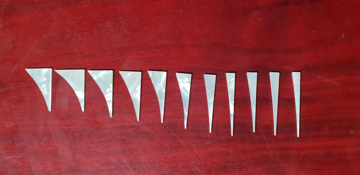 <p>A set of 11pcs White MOP Shark fin inlays. Thickness 1.5mm. Flat and ready to be installed.</p>