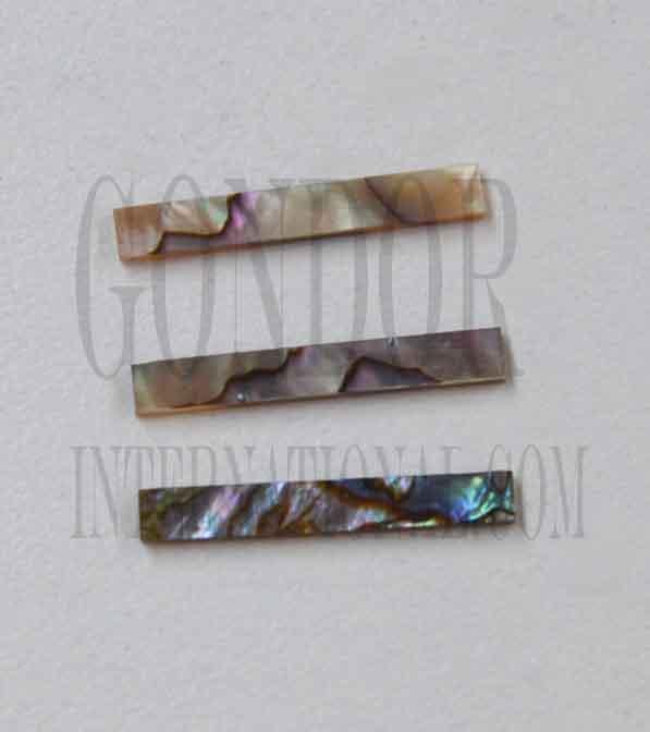 Green abalone solid shell straight strips 3.4mm (0.134") width x 25mm (1") length x 1.3mm (0.05") thickness. A grade quality good on both sides, flat and uniform in thickness and width. Ideal for use in purfling on musical instruments - Ukuleles, guitars, mandolins etc. as well as in furniture, jewellery ans other decorative applications.