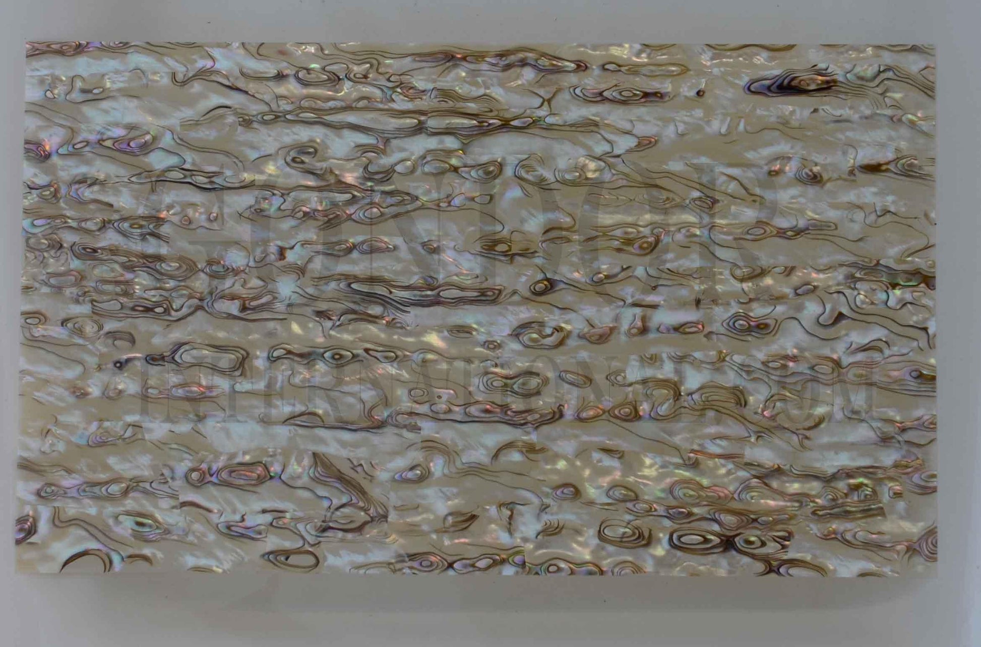 Pink abalone veneer also called Pink abalone sheet or Pink abalone shell paper. Made from thin slices of genuine shell. Standard sheet size 140mm (5.51") width x 240mm (9.45") length x 0.15mm (0.006") thickness Suitable for signwriting, fishing lures, jewellery, architectural application, furniture, surfboards and many other applications.