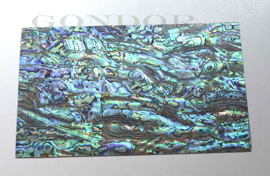 New Zealand Paua shell laminated shell sheets A grade blue, green, pink colour made from genuine shell. Each sheet has shell throughout consisting of layers of smaller shell pcs. Sheet size 235 x 135mm (9.25 x 5.3"). Thickness 1.3mm (0.05") Ideal for inlay work, jewellery, knife handles. Economical and easy to cut. All layers are A grade same consistency throughout the sheet.