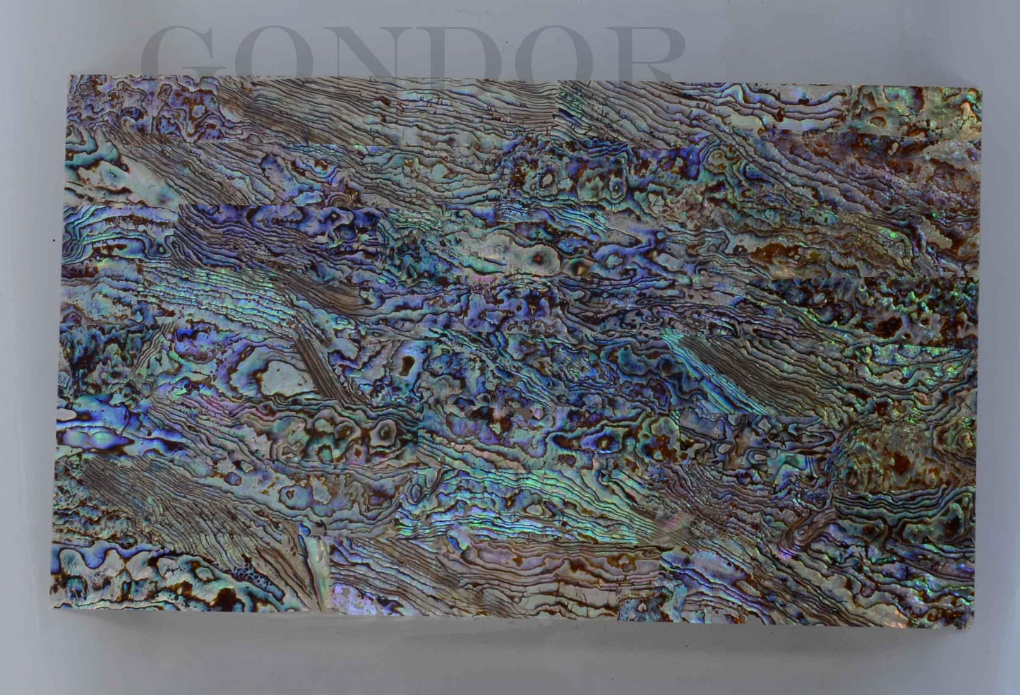 New Zealand Paua shell laminated shell sheets B grade mixed blue, green, pink colour made from genuine shell. Each sheet has shell throughout consisting of layers of smaller shell pcs. Sheet size 235 x 135mm (9.25 x 5.3"). Thickness 1mm (0.04") Ideal for inlay work, jewellery, knife handles. Economical and easy to cut. All layers are same consistency throughout the sheet.