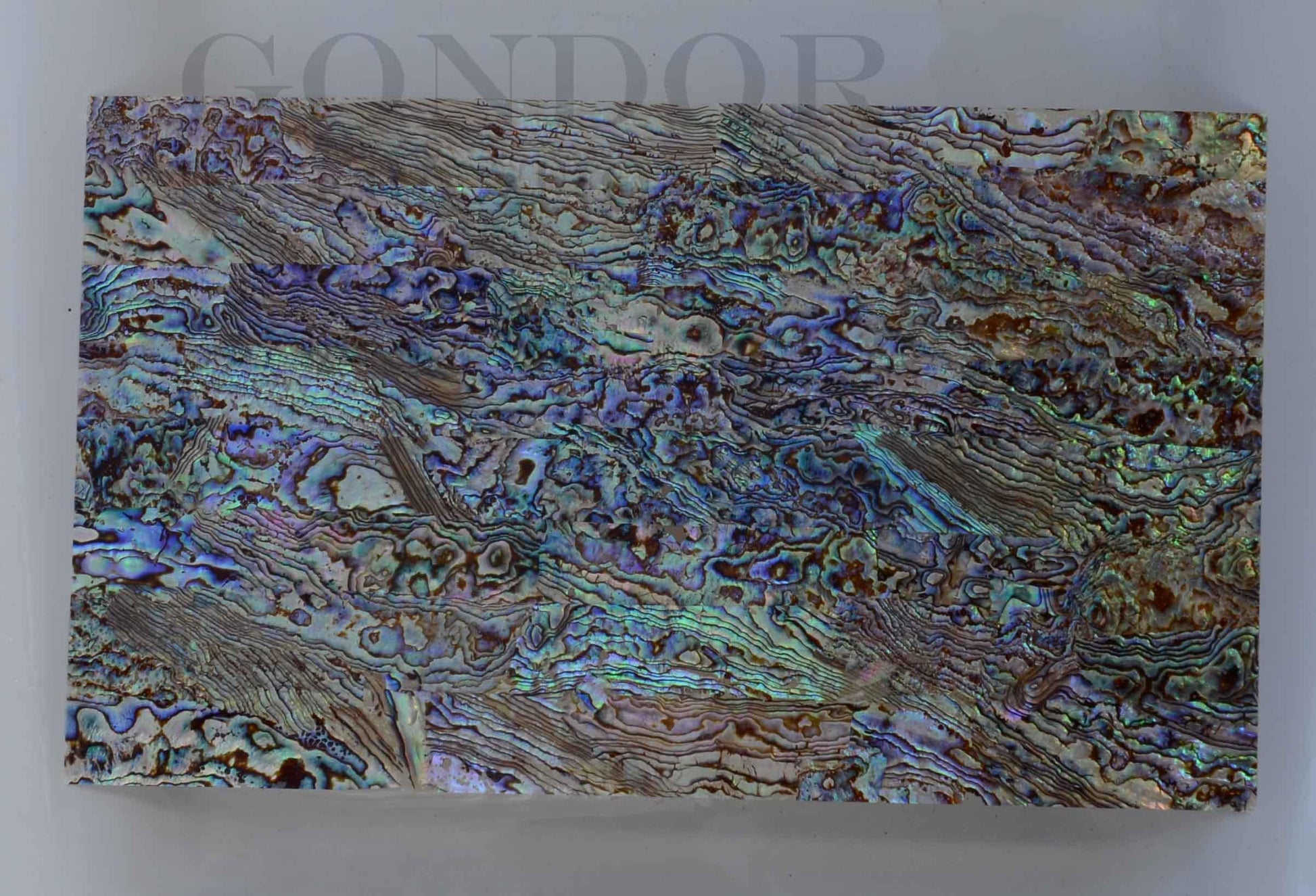 New Zealand Paua shell laminated shell sheets B grade mixed blue, green, pink colour made from genuine shell. Each sheet has shell throughout consisting of layers of smaller shell pcs. Sheet size 235 x 135mm (9.25 x 5.3"). Thickness 2.5mm (0.1") Ideal for inlay work, jewellery, knife handles. Economical and easy to cut. All layers are same consistency throughout the sheet.