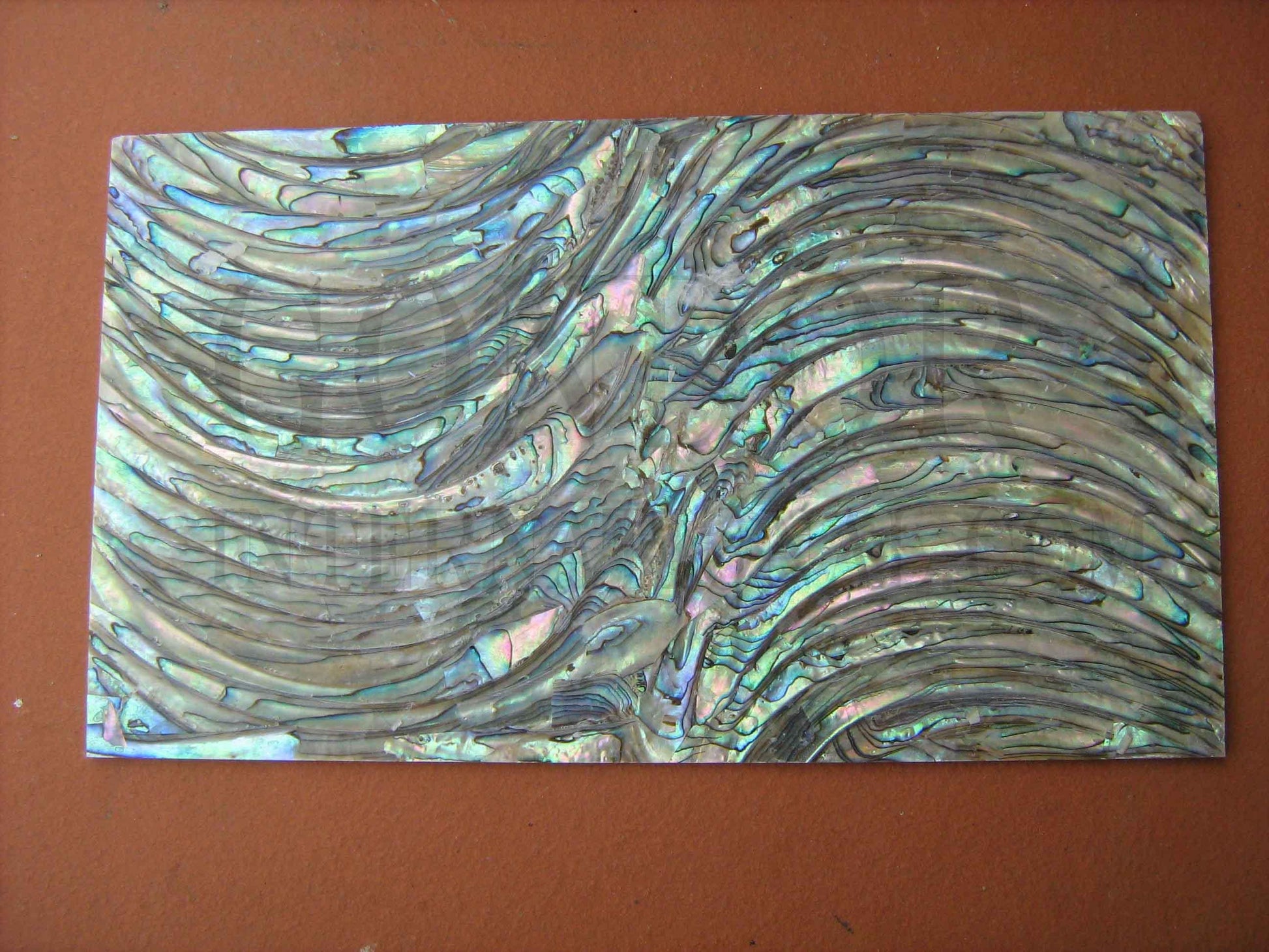 Paua rim veneer also called Paua rim sheet or Paua rim shell paper. Made from thin slices of genuine shell. Standard sheet size 140mm (5.51") width x 240mm (9.45") length x 0.3mm (0.012") thickness Suitable for signwriting, fishing lures, jewellery, architectural application, furniture and many other applications.