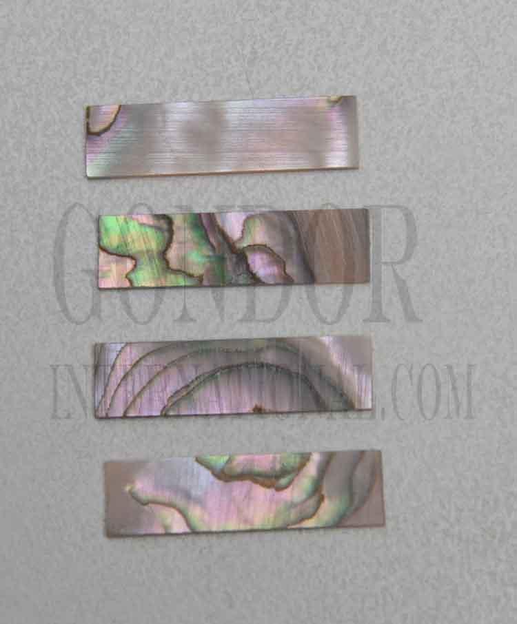 Red abalone solid shell straight strips 9.52mm (3/8") width x 25mm (1") length x 1.3mm (0.05") thickness. A grade quality good on both sides, flat and uniform in thickness and width. Ideal for use in purfling on musical instruments - Ukuleles, guitars, mandolins etc. as well as in furniture, jewellery ans other decorative applications.