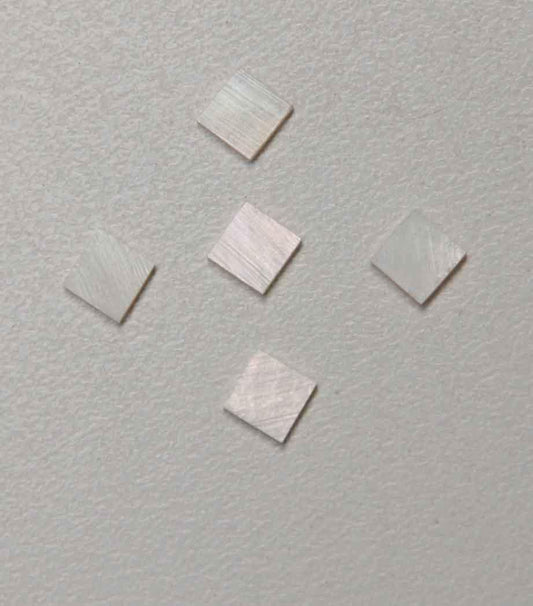 <p>White Mother of Pearl flat nut blanks size 10mm (0.394") width x 10mm (0.394") length x 1.3mm (0.05") thickness A grade good on both sides.</p>