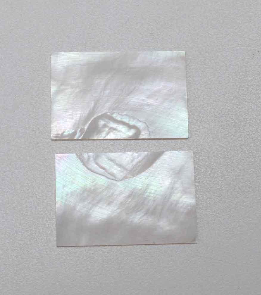 <p>White Mother of Pearl flat inlay blanks size 40mm (1.57") width x 60mm (2.36") length x 1.5mm (0.06") thickness. A grade good on both sides.</p>