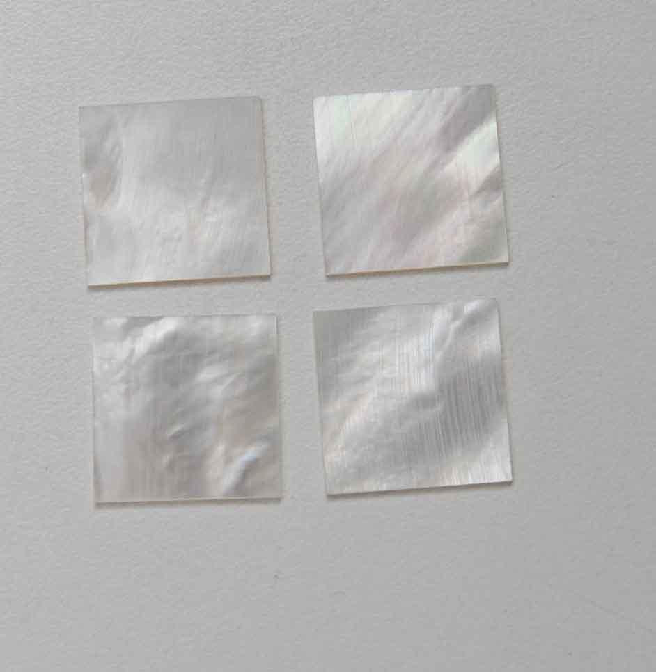 <p>White Mother of Pearl flat inlay blanks size 50mm (1.97") width x 50mm (1.97") length x 1.5mm (0.06") thickness. A grade good on both sides.</p>