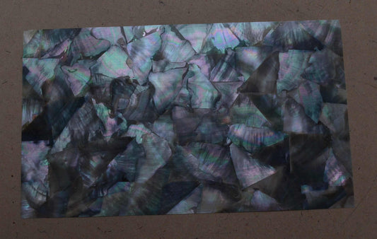 <p>Black Mother of Pearl laminated shell sheets A random cut are made from genuine shell. Each sheet has shell throughout consisting of layers of smaller shell pcs. Sheet size 235 x 135mm (9.25 x 5.3"). Thickness 0.5mm  (0.02") Ideal for inlay work, jewellery, knife handles. Economical and easy to cut. All layers are A grade same consistency throughout the sheet. </p>