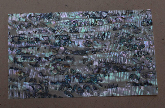 Green abalone B grade laminated shell sheets are made from genuine shell. Each sheet has shell throughout consisting of layers of smaller shell pcs. Sheet size 235 x 135mm (9.25 x 5.3"). Thickness 0.5mm (0.02") Ideal for inlay work, marquetry, jewellery, knife handles. Economical and easy to cut. All layers are same consistency throughout the sheet.