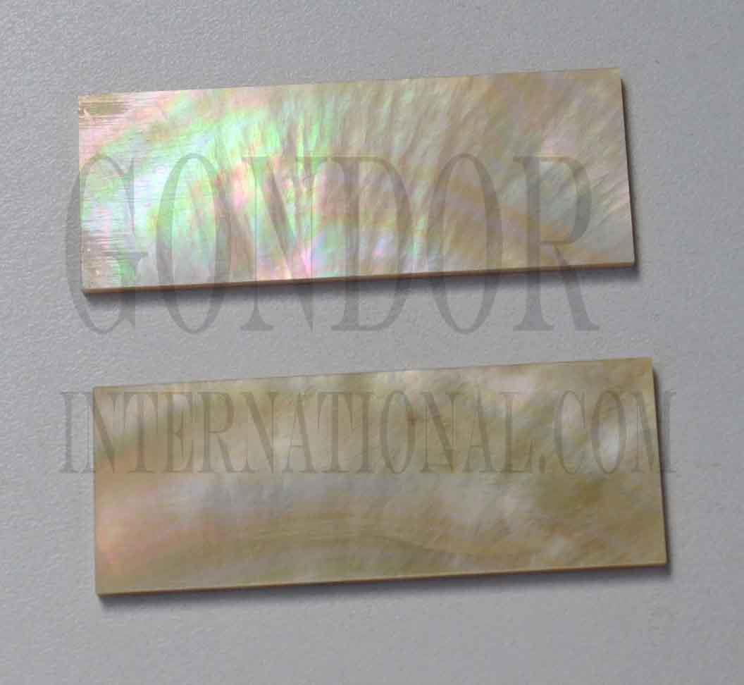 Gold MOP shell inlay feathers consist of single piece solid shell face layer 0.5mm thick laminated to shell laminate backing size 32 width x 110-120mm length  x .1.6mm total thickness  (including 1.1mm laminated sheet backing). Suitable for inlays, marquetry. <br />