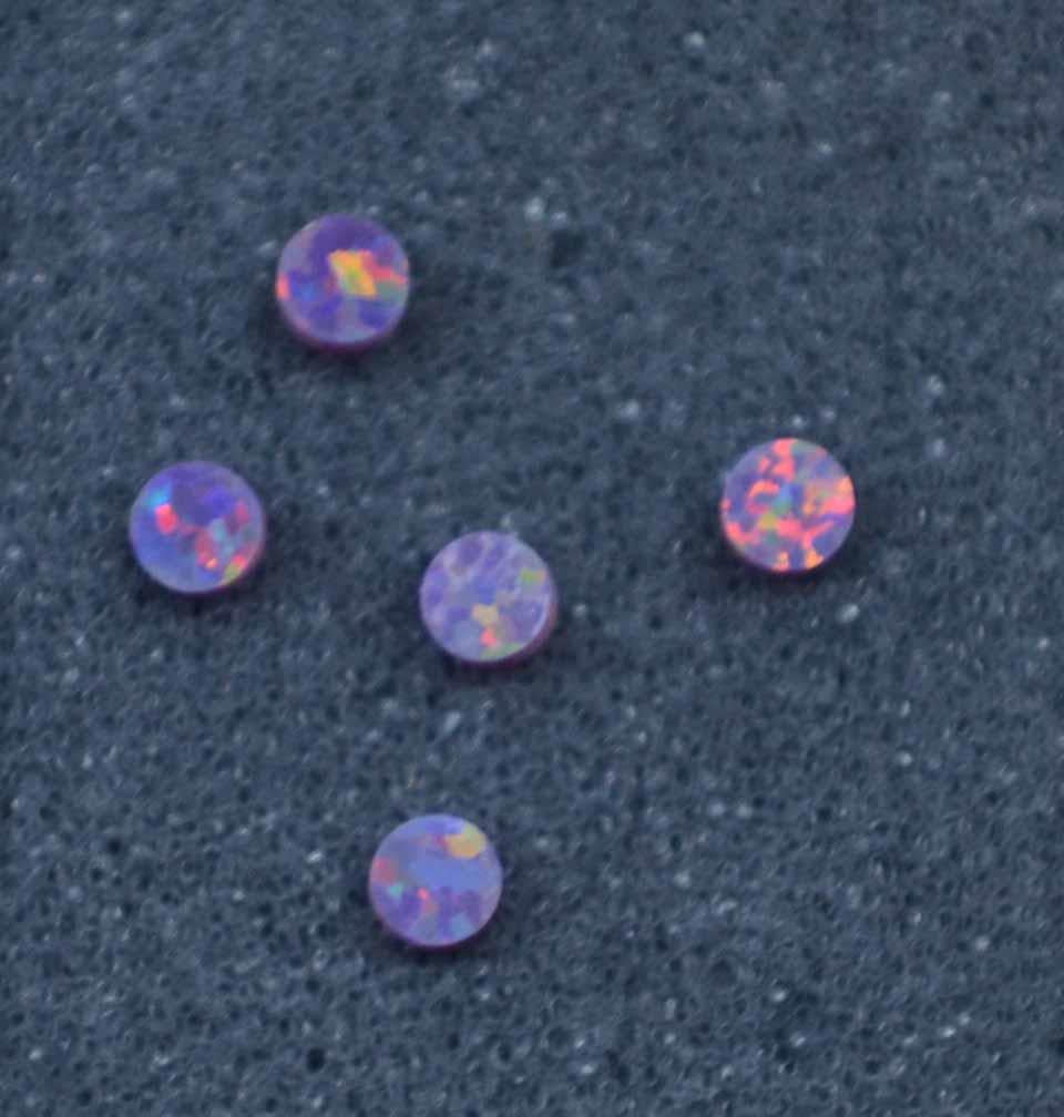 <p>Opal dots OP76 2 x 1.3mm flat pcs made to specific diameter and thickness made from manufactured opal suitable for inlay, fingerboard markers, jewellery, Opal dots can be worked same way as mother of pearl and are of similar hardness.</p>