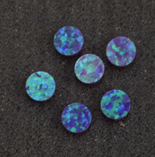 <p>Opal dots OP52 5 x 1.3mm flat pcs made to specific diameter and thickness made from manufactured opal suitable for inlay, fingerboard markers, jewellery, Opal dots can be worked same way as mother of pearl and are of similar hardness.</p>