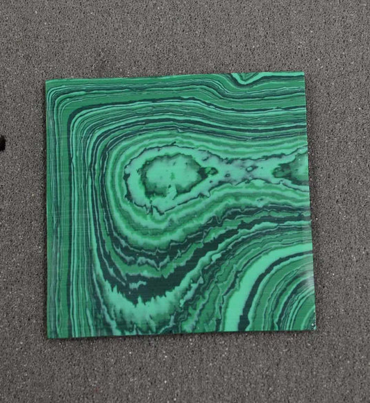 <p>Malachite H01 reconstituted stone blanks 50 x 50 x 1.5mm suitable for inlay. Can be cut with standard cutting tools - jewellery saw similar in characteristics to mother of pearl (hardness approx. 3. Can be sanded and polished same way as shell material. All pcs are A grade good on both sides.</p>