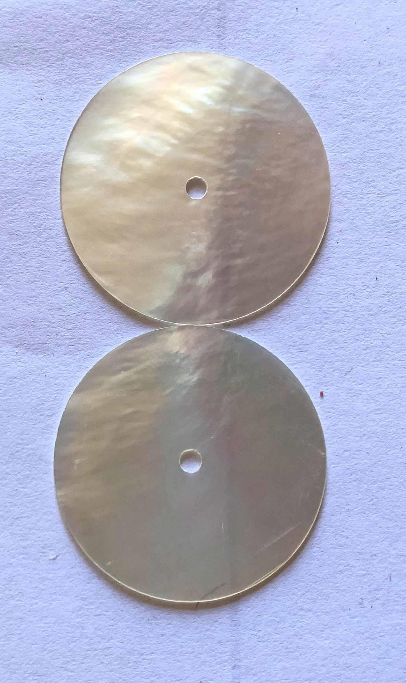 <p>White Mother of Pearl polished discs 28.5mm (1.12") diameter x 0.45mm (0.02") thickness 2mm center hole- round flat shell pcs polished 1 side cut to precise diameter and thickness. Ideal for watch dials and jewellery decorations. All discs are A grade good on both sides.</p>