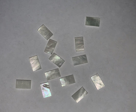 <p>White Mother of Pearl flat inlay blanks size 5mm (0.2") width x 8.6mm (0.34") length x 1mm (0.04") thickness. A grade good on both sides.</p>