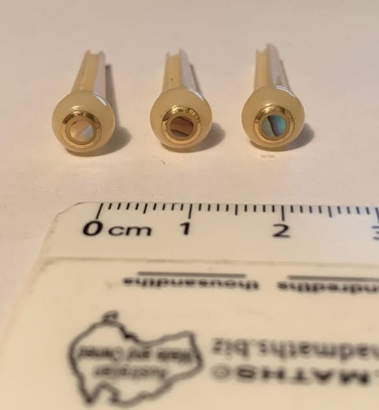 1 set (6pcs) Guitar bridge pins  size 2A Vintage bone with brass and Paua dot. Tapered shaft string slot running the full length of shaft. Diameter at top of shaft 5.6mm (0.22") length of shaft 25.5mm (1") . Will fit the following models - Martin guitars since 1994,as well as D-28 older Gibson guitars,and others.