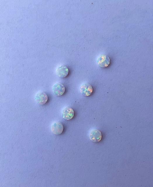 <p>Opal dots OP17 3 x 1.3mm flat pcs made to specific diameter and thickness made from manufactured opal suitable for inlay, fretboard markers, jewellery, Opal dots can be worked same way as mother of pearl and are of similar hardness.</p>