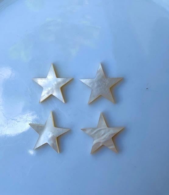 <p>White Mother of Pearl 5 point stars size 17mm (0.7") square x 1.5mm (0.06") thickness. Some uses include fretboard markers, musical instrument inlay, furniture inlay, marquetry, pool cue inlay and other general decorative inlay and jewellery applications. All pcs are A grade.</p>