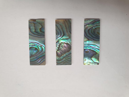 <p>Paua abalone (New Zealand Paua shell) flat inlay blanks size 12mm (0.47") width x 35mm (1.38") length x 2mm (0.08") thickness A grade good on at least 1 side may have some worm damage or shell skin on edges of reverse side.</p>