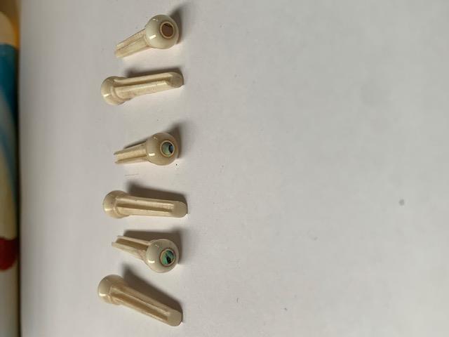 1 set (6pcs) Guitar bridge pins bone brass with paua shell dot size 1 Tapered shaft string slot running the full length of shaft. Diameter at top of shaft 5.3mm (0.21") length of shaft 22.9mm (0.9") . Will fit the following models - Martin guitars prior to 1994 (except HD-28), Collings guitars, prior to 2002, Blanchard, Garrison, Goodall, Ryan, Santa Cruz, Taylor, Larrivee D-03R and others.